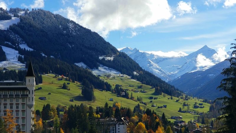 Gstaad Palace, chalet buildings and mountain slopes in autumn, photographed in October 2020.